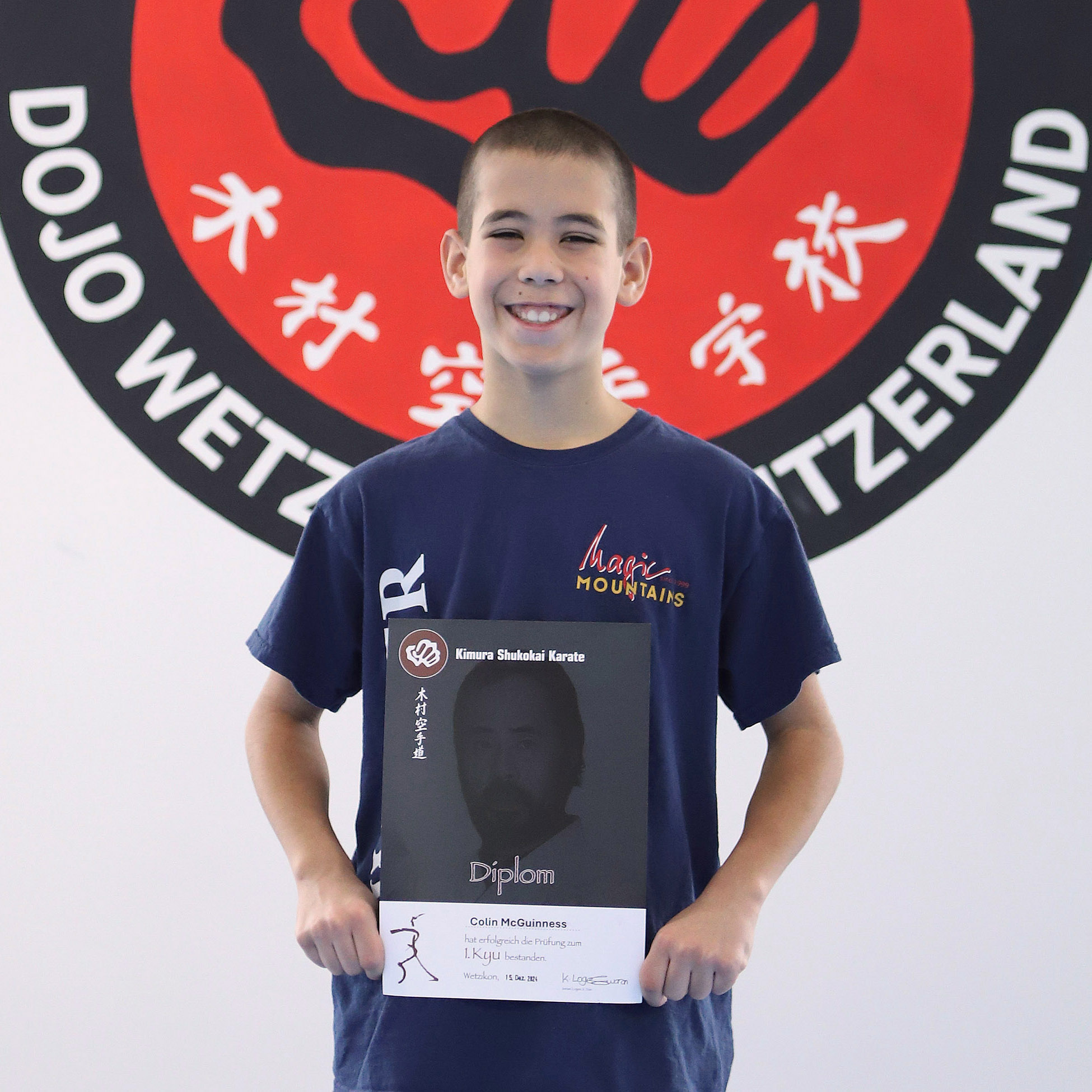 Colin McGuinness at his his final brown belt exam (1st kyu) Colin McGuinness showing his certificate after passing his final brown belt exam (1st kyu)