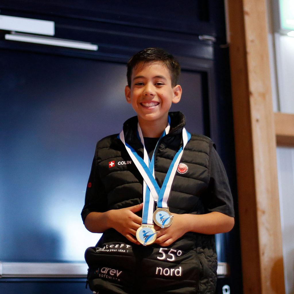 Colin McGuinness at the medal ceremony at the Zurich Karate Championship 2025 wearing both his medals.