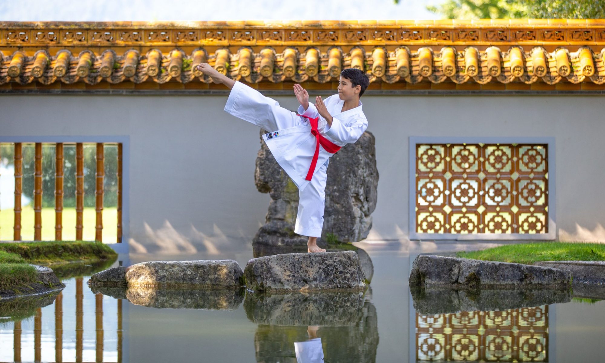 Colin McGuinness demonstrating a karate kick at the Chinese garden in Zurich, Switzerland